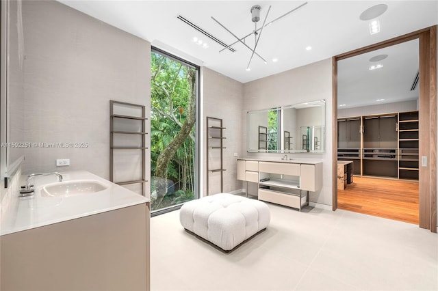 bathroom with vanity, tile patterned flooring, and expansive windows