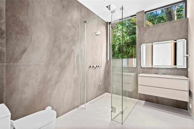 bathroom with vanity, a wealth of natural light, a shower with door, and toilet