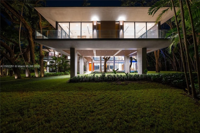5245 Oak Ln, Coral Gables, FL 33156 - back of house at twilight with a yard