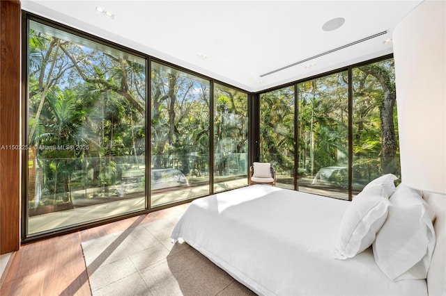 bedroom featuring floor to ceiling windows, multiple windows, and access to outside