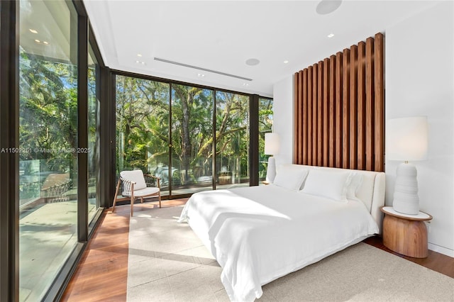 bedroom featuring expansive windows and access to outside