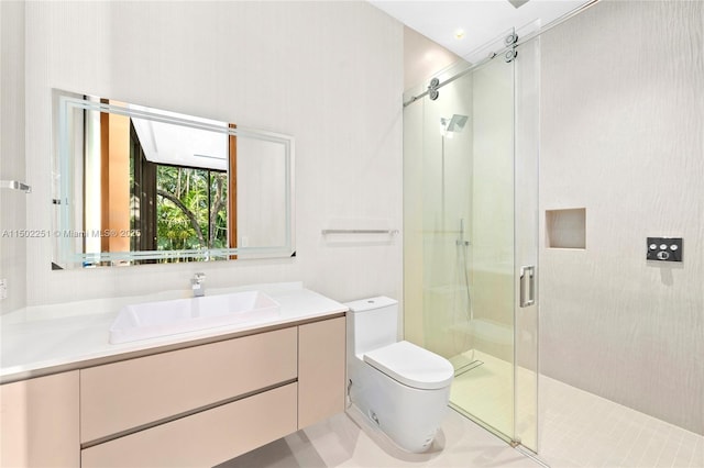 bathroom with vanity, toilet, and a shower with door