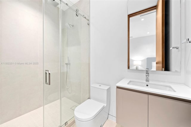 bathroom with vanity, a shower with shower door, and toilet