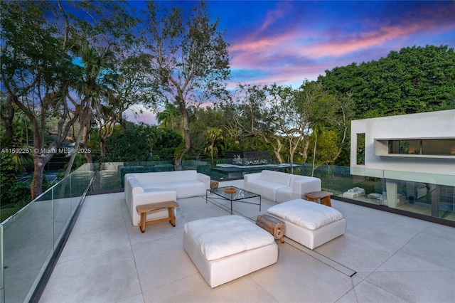 patio terrace at dusk featuring an outdoor hangout area