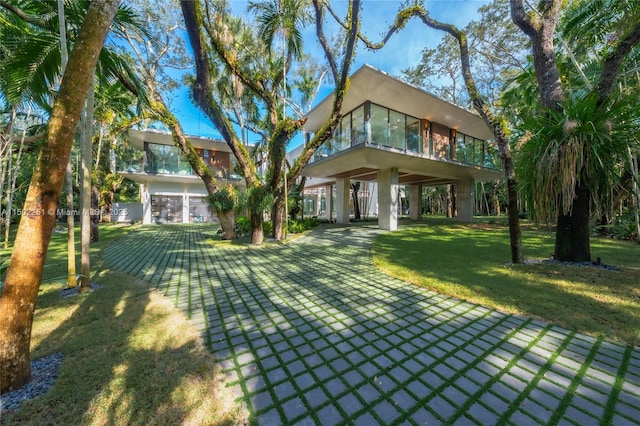 rear view of property featuring a lawn