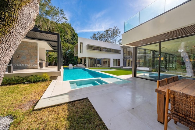 view of swimming pool featuring a patio and an in ground hot tub