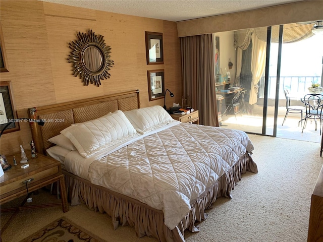 carpeted bedroom with a textured ceiling and access to outside