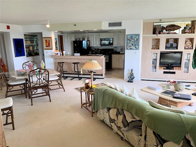 carpeted living room featuring a textured ceiling