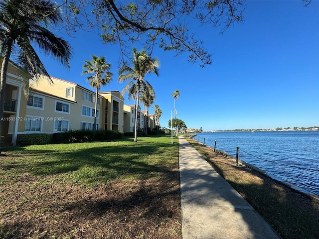 view of home's community with a yard and a water view