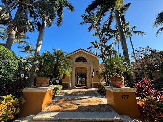 property entrance with french doors and stucco siding