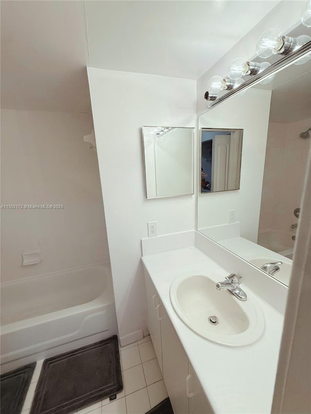 bathroom featuring  shower combination, vanity, and tile patterned floors