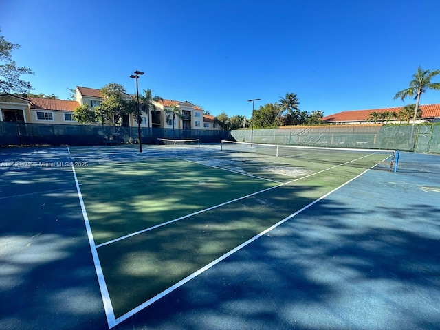 view of sport court featuring fence