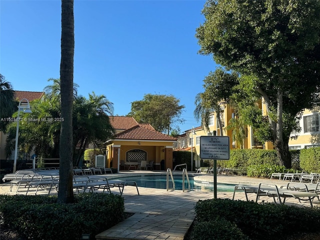 pool featuring a patio area and fence