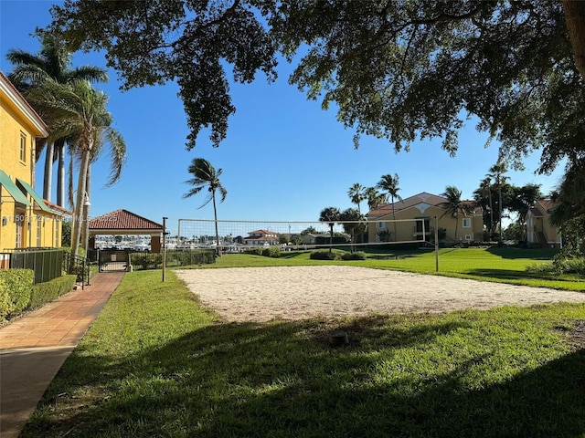 view of property's community with volleyball court, a lawn, and a gazebo