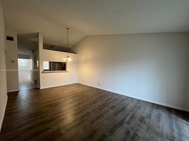 unfurnished living room with a chandelier, dark hardwood / wood-style floors, and vaulted ceiling