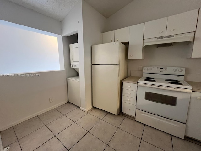 kitchen featuring lofted ceiling, white appliances, stacked washer and dryer, a textured ceiling, and white cabinetry