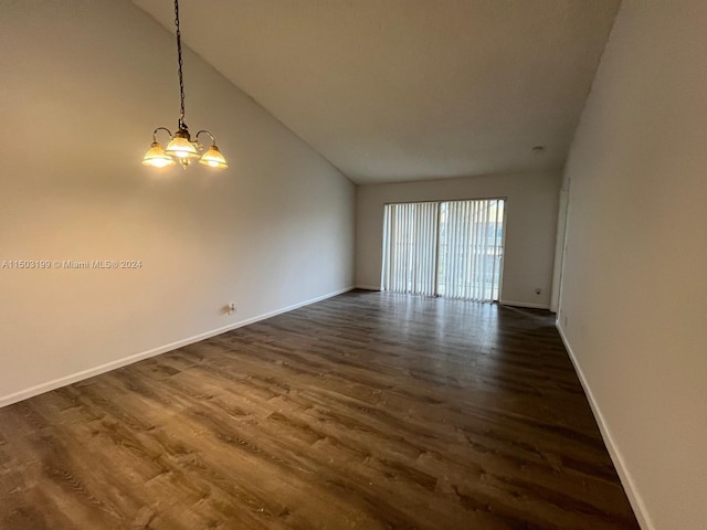 unfurnished room with lofted ceiling, a chandelier, and dark hardwood / wood-style floors