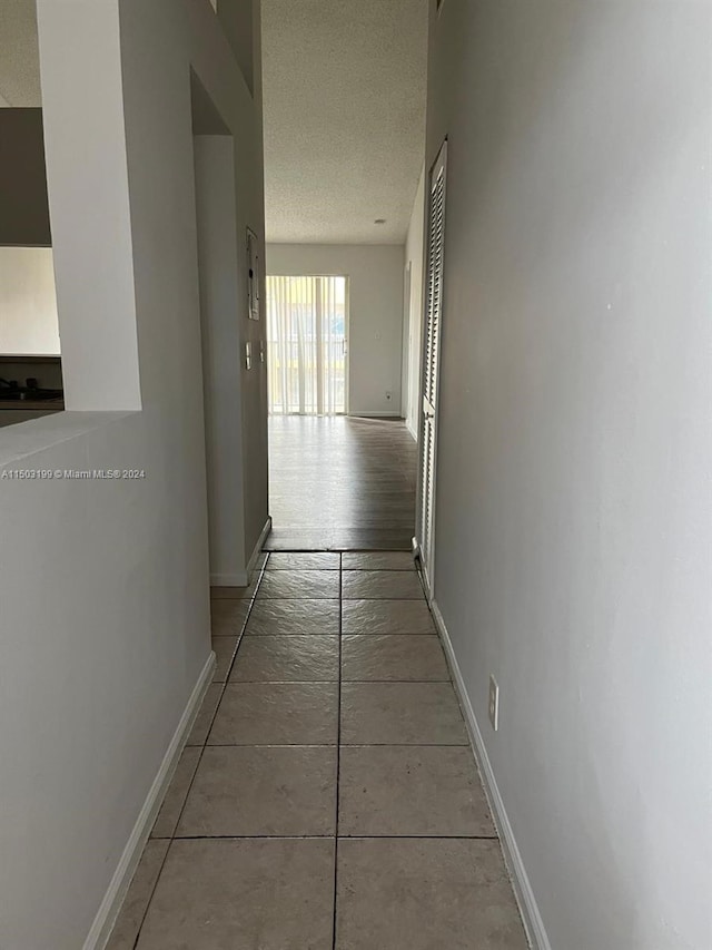 hallway with a textured ceiling