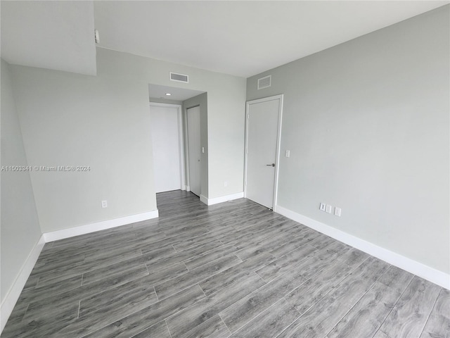 unfurnished room featuring hardwood / wood-style flooring