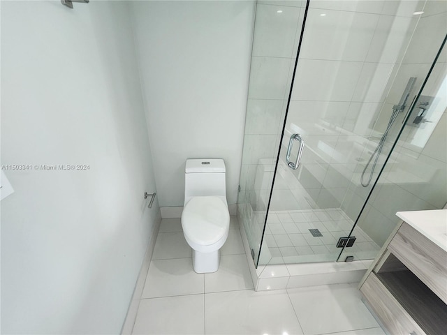 bathroom featuring tile patterned flooring, vanity, toilet, and an enclosed shower