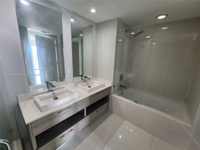 bathroom with tile patterned floors, vanity, and tiled shower / bath