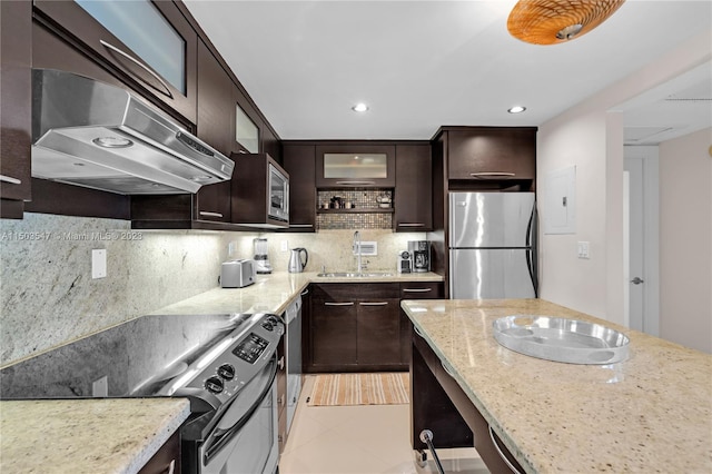 kitchen featuring appliances with stainless steel finishes, sink, dark brown cabinets, light tile patterned floors, and decorative backsplash