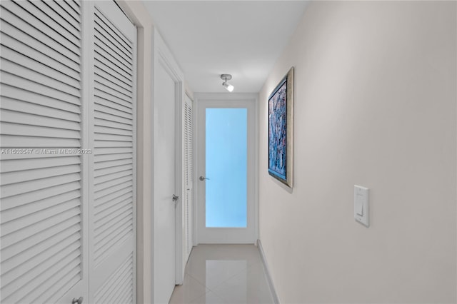 hall with light tile patterned floors