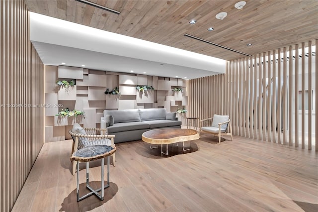 living room featuring light hardwood / wood-style floors and wood ceiling