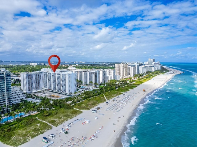 birds eye view of property with a view of the beach and a water view