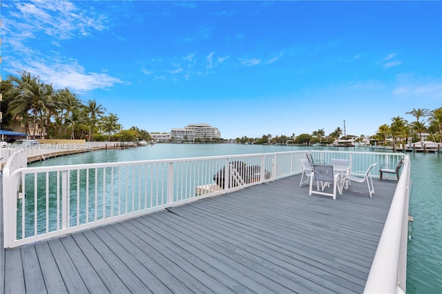 view of dock with a deck with water view