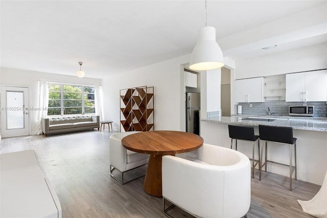 interior space featuring light wood-type flooring and sink