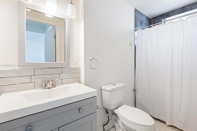 bathroom featuring vanity, tile walls, toilet, and backsplash