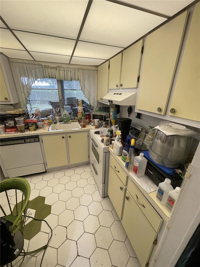 kitchen featuring sink, light tile patterned floors, and white appliances