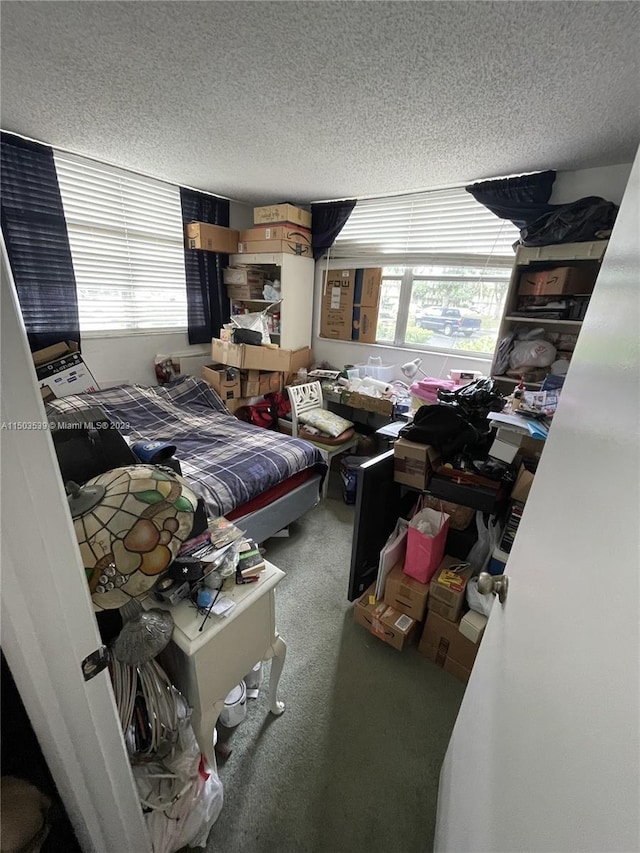 carpeted bedroom featuring a textured ceiling