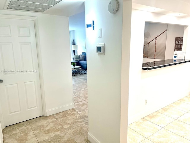 hallway with light tile patterned floors