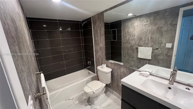 full bathroom with tiled shower / bath, vanity, and toilet