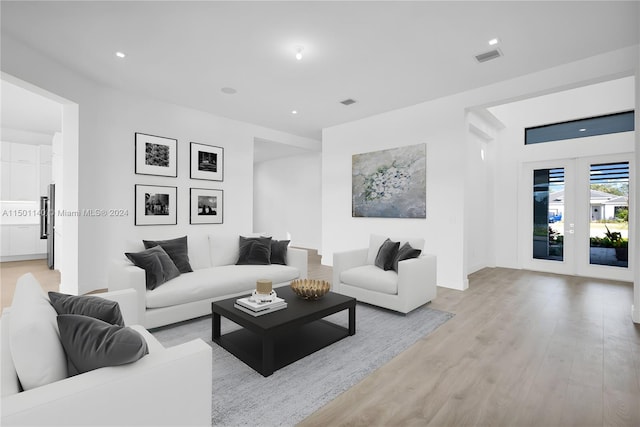 5735 SW 104th Ter, Cooper City, FL 33328 - living room with french doors and light hardwood / wood-style flooring