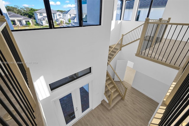 5735 SW 104th Ter, Cooper City, FL 33328 - stairs featuring a towering ceiling and light hardwood / wood-style flooring