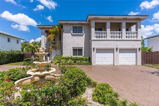 view of front of house featuring a garage and a balcony