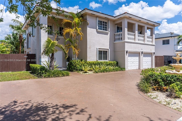 view of front of house with a garage and a balcony