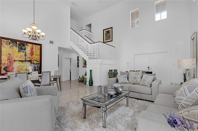 living room with a towering ceiling, tile flooring, and an inviting chandelier