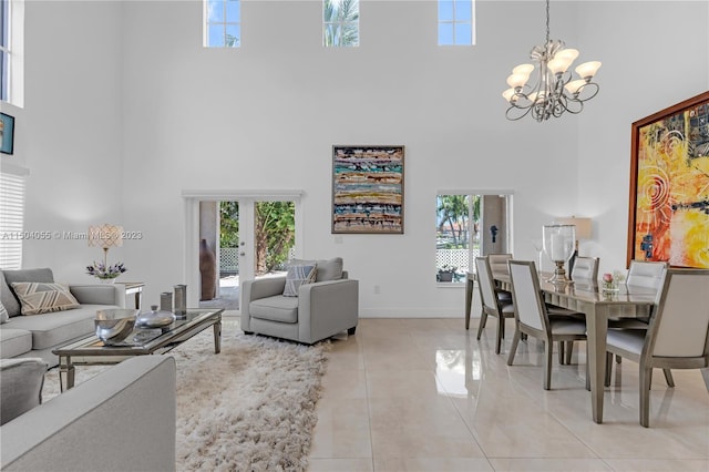 dining room with an inviting chandelier, a towering ceiling, and light tile flooring