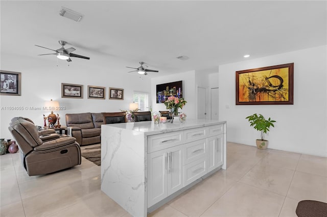 living room featuring ceiling fan and light tile floors