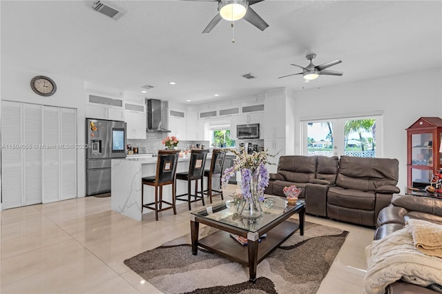 tiled living room with ceiling fan