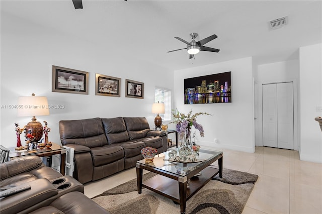 tiled living room with ceiling fan