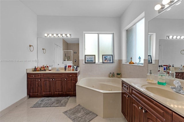 bathroom featuring a bath, dual sinks, tile flooring, and large vanity