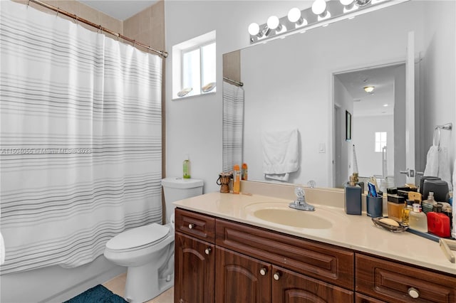 bathroom featuring a wealth of natural light, toilet, and vanity