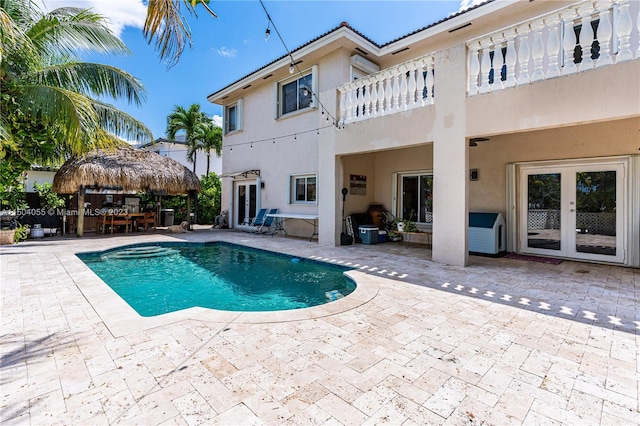 view of swimming pool with a patio area, a gazebo, and french doors