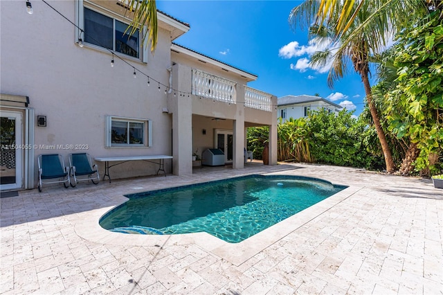 view of swimming pool with a patio