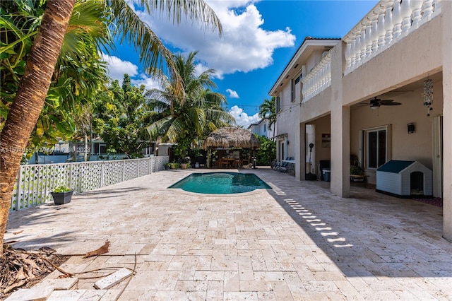 view of pool with a patio and ceiling fan